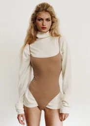 Model wearing a white turtleneck under a tan bodysuit against a clean off-white studio background.