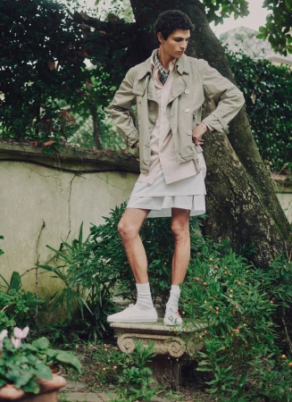 Model wearing a light jacket standing outdoors in a garden for ICON Magazine Mena.