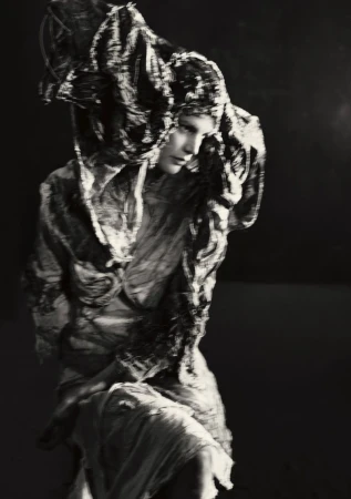 Model Saskia de Brauw in textured dark garments and elaborate headdress for Luncheon Magazine photographed by Paolo Roversi.