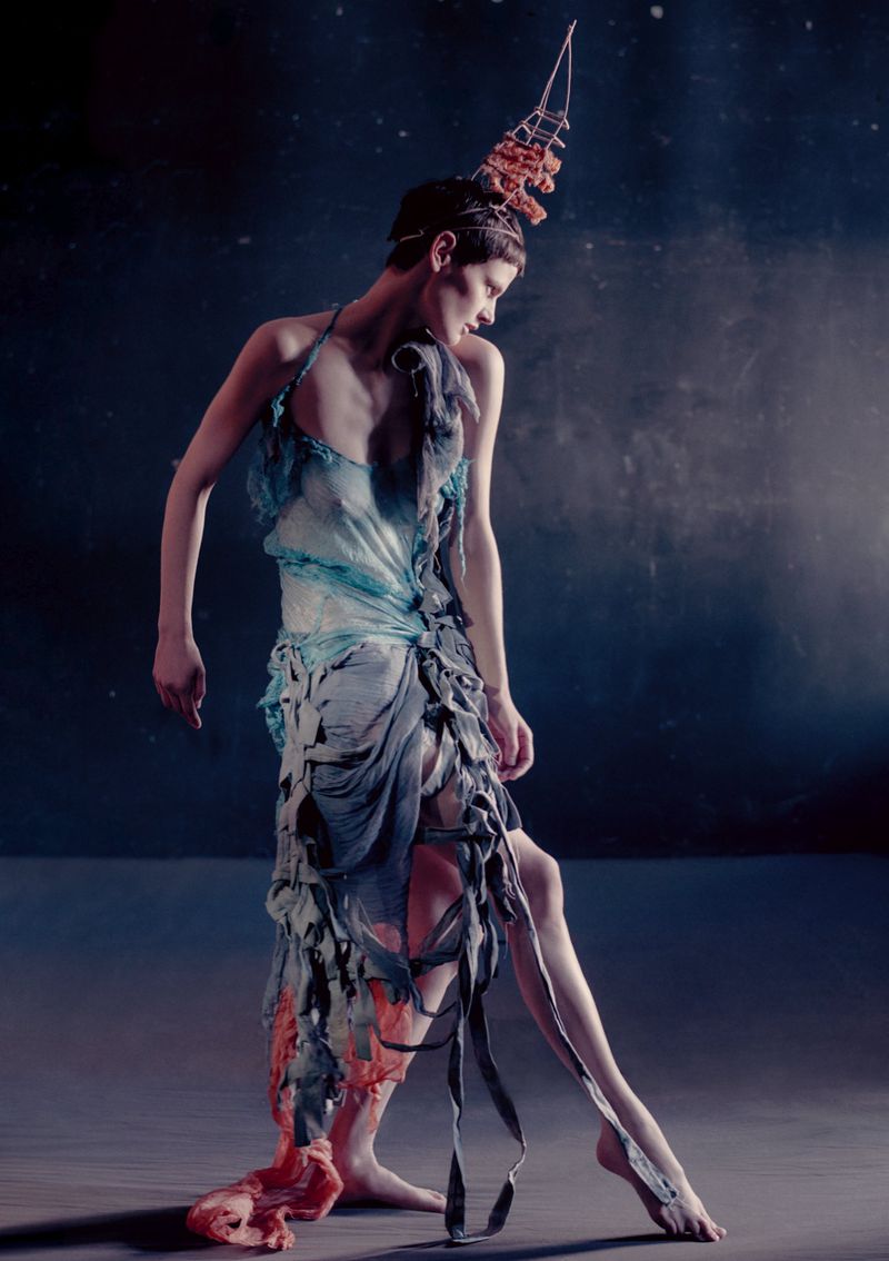 Model Saskia de Brauw in an avant-garde blue and grey dress with structural headdress for Luncheon Magazine