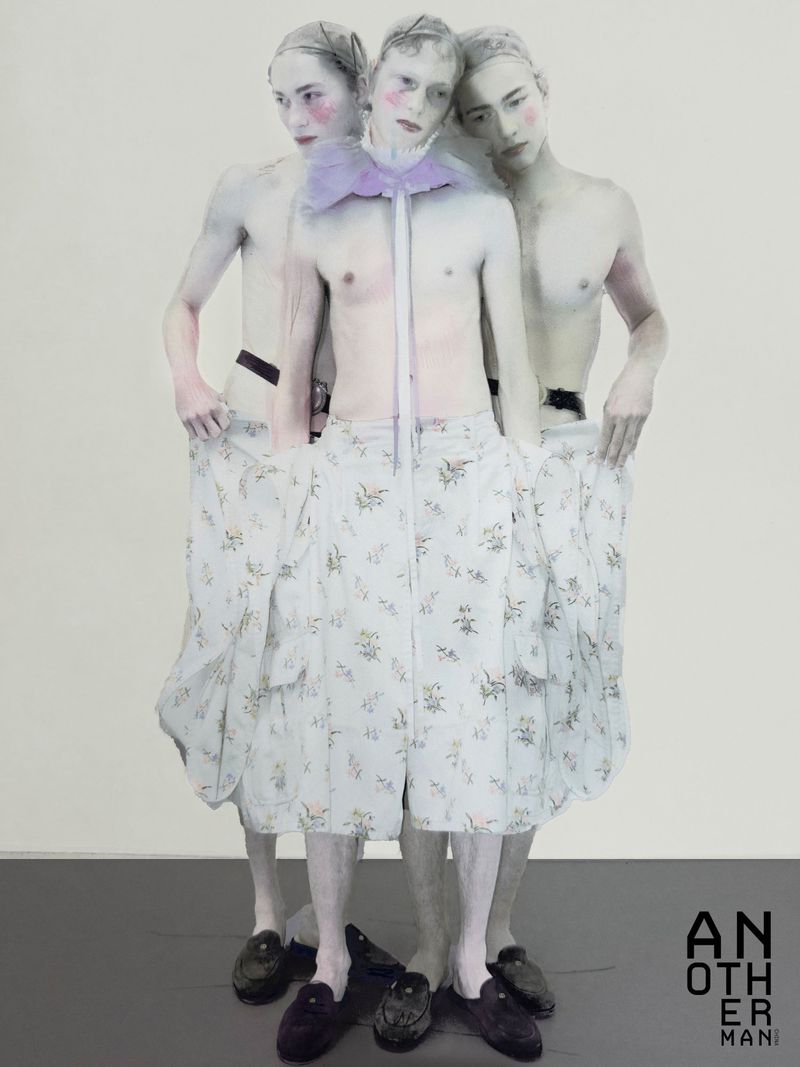 Three male models with pale painted skin and floral shorts standing together against a light background for AnOther Man China
