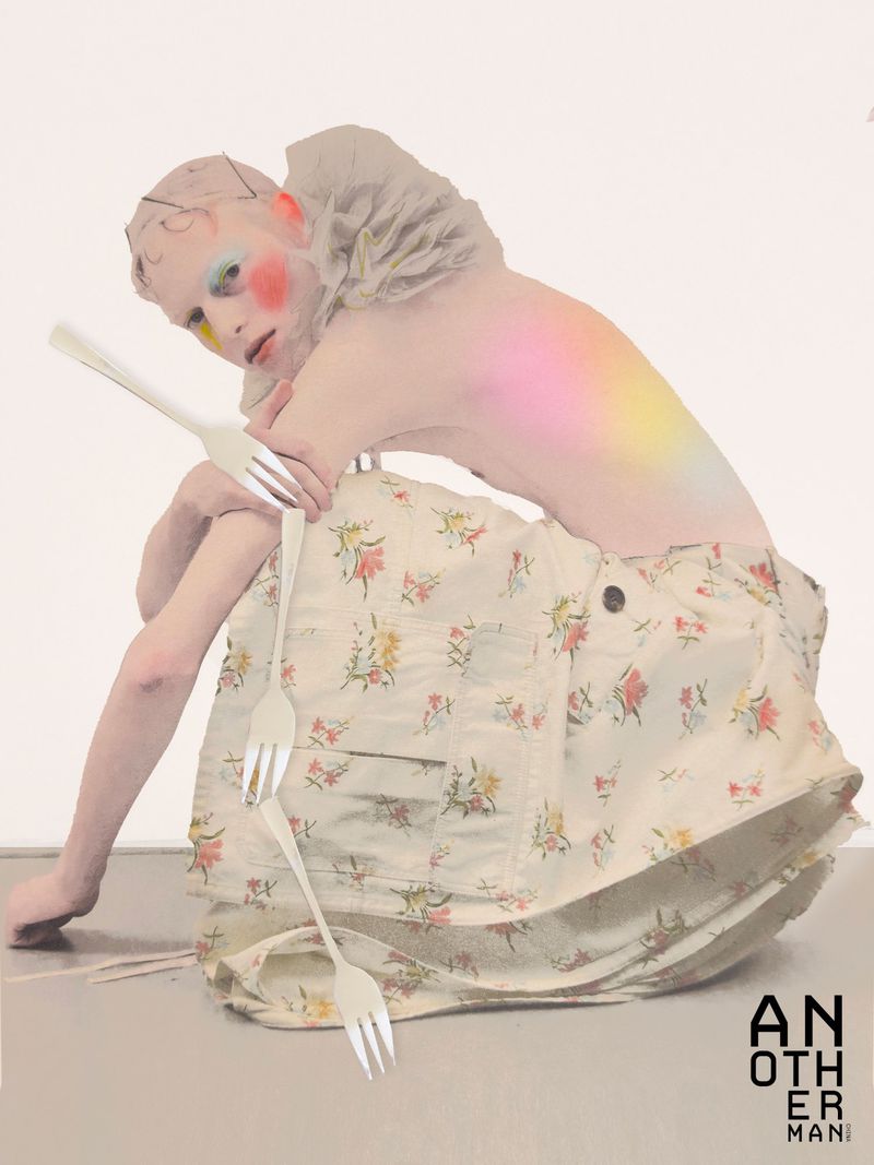Model with painted cheeks and ruffled collar wearing a floral skirt, posed with plastic forks