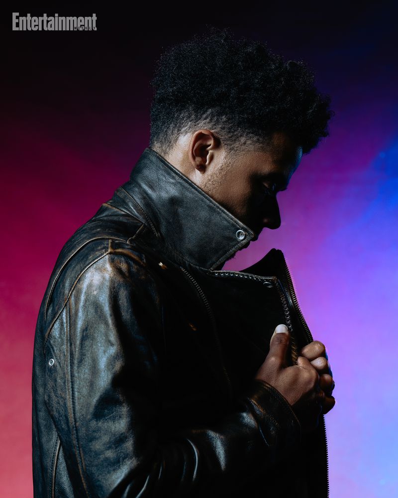 Profile of a black man wearing a dark leather jacket against a red and blue gradient background for Entertainment Weekly