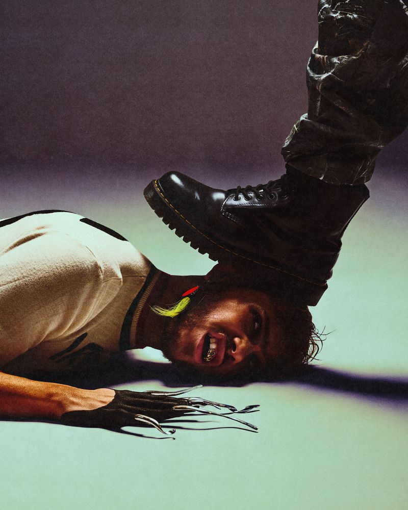 Man lying on the floor with a heavy black boot stepping on his head, shot for Fault Magazine by Gustavo Chams.