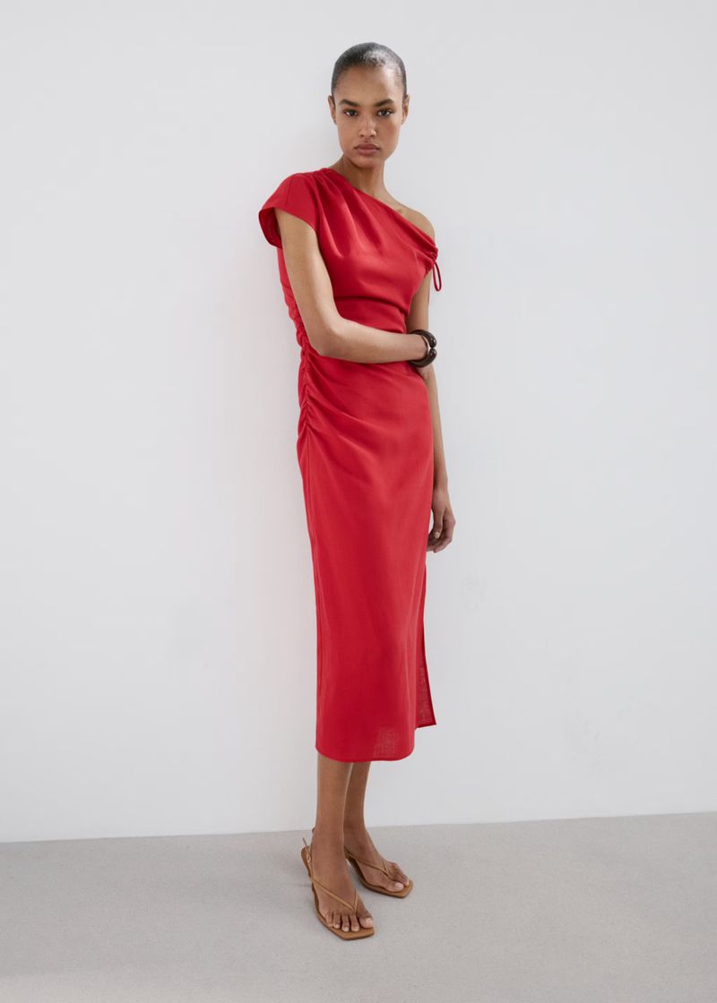 Ana Beatriz Cortes wearing a draped red midi dress against a plain white studio background for Mango S/S 26