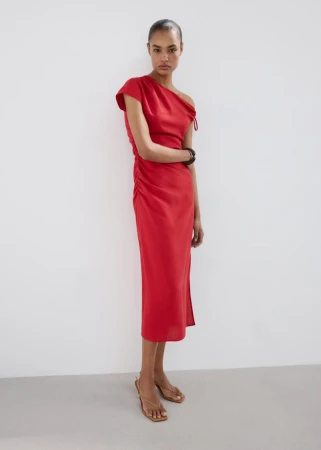 Ana Beatriz Cortes wearing a draped red midi dress against a plain white studio background for Mango S/S 26