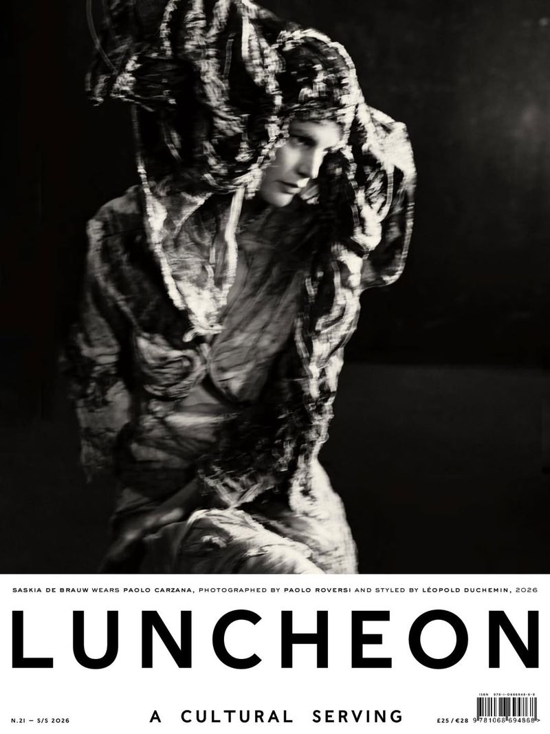 Monochrome fashion photography of a woman with draped fabric and ornate head covering, with Luncheon magazine text overlay.