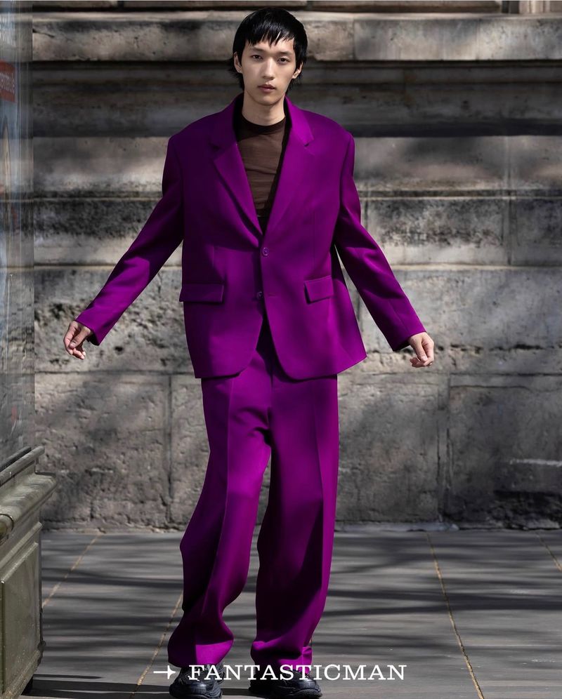Model wearing a vibrant purple suit standing on a stone street for Fantastic Man China fashion project.