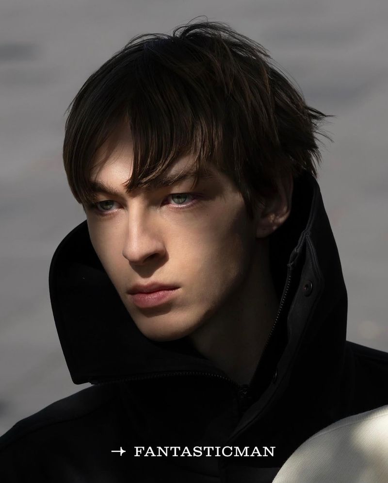Close-up portrait of a male model in a black jacket against a neutral outdoor background for Fantastic Man China.