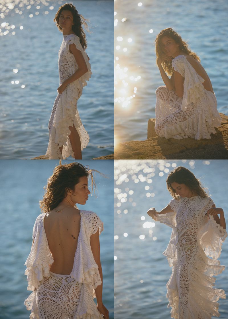Model in white lace dress by the sea for Elle France editorial Voyage En Italie