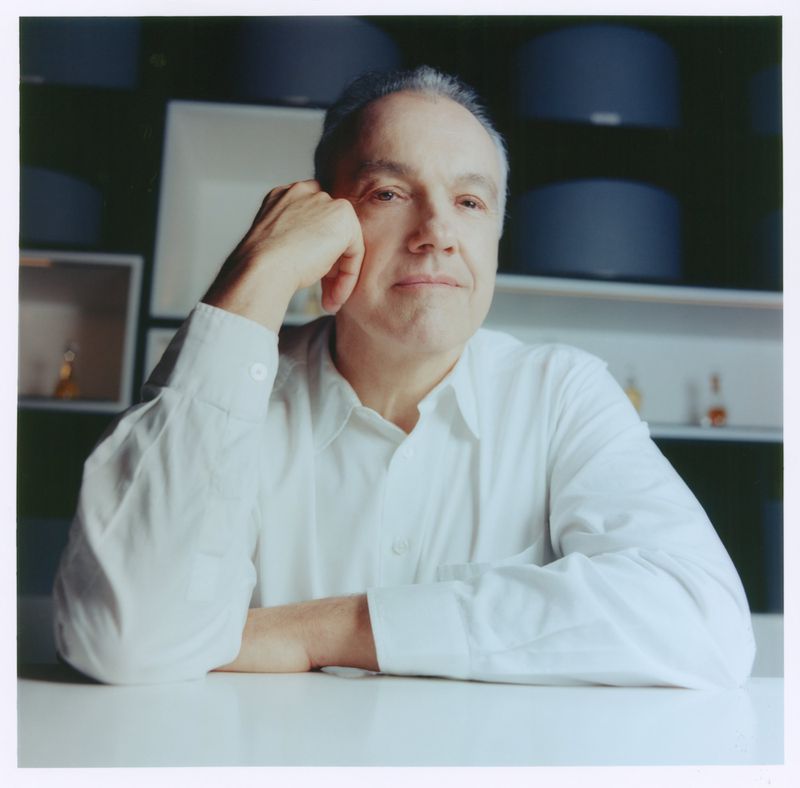 Portrait of an older man wearing a white shirt with his hand on his chin for ODDA Magazine