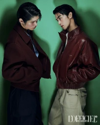 Two male models posing against a green backdrop for L'Officiel Korea, wearing leather jackets and cargo trousers.