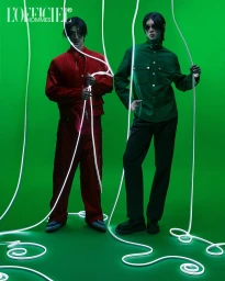 Two male models posing on a green backdrop surrounded by glowing white neon string lights for L'Officiel Korea Duo project.