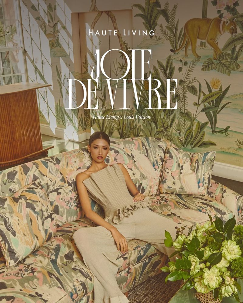 Model seated on a patterned floral sofa in a brightly lit room for a magazine editorial featuring bold typography overlay.
