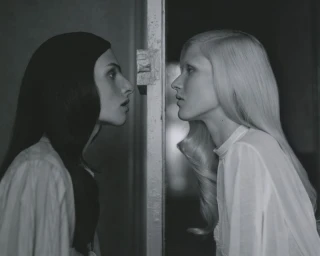 Two female models facing each other in profile against a doorway for Vogue Ukraine Vakare plus Lou project