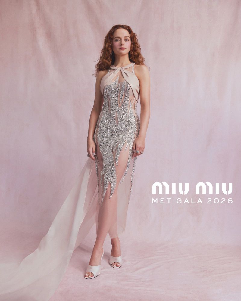 Joey King wearing a crystal-embellished halter gown by Miu Miu against a pale pink textured backdrop with white text.