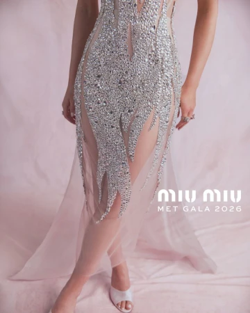 Close-up of Joey King wearing an embellished crystal sheer Miu Miu gown against a soft pink draped backdrop.