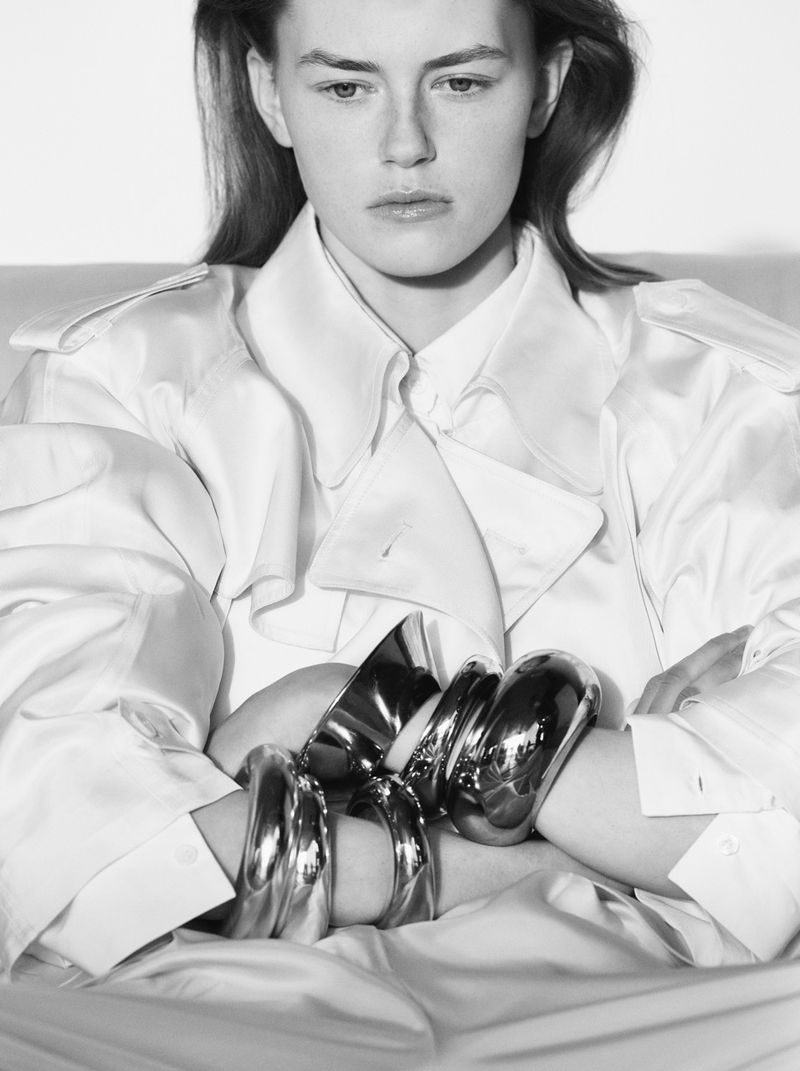 Model wearing a white trench coat and silver bangles for The Frankie Shop S/S 26 campaign photographed by Sarah Blais