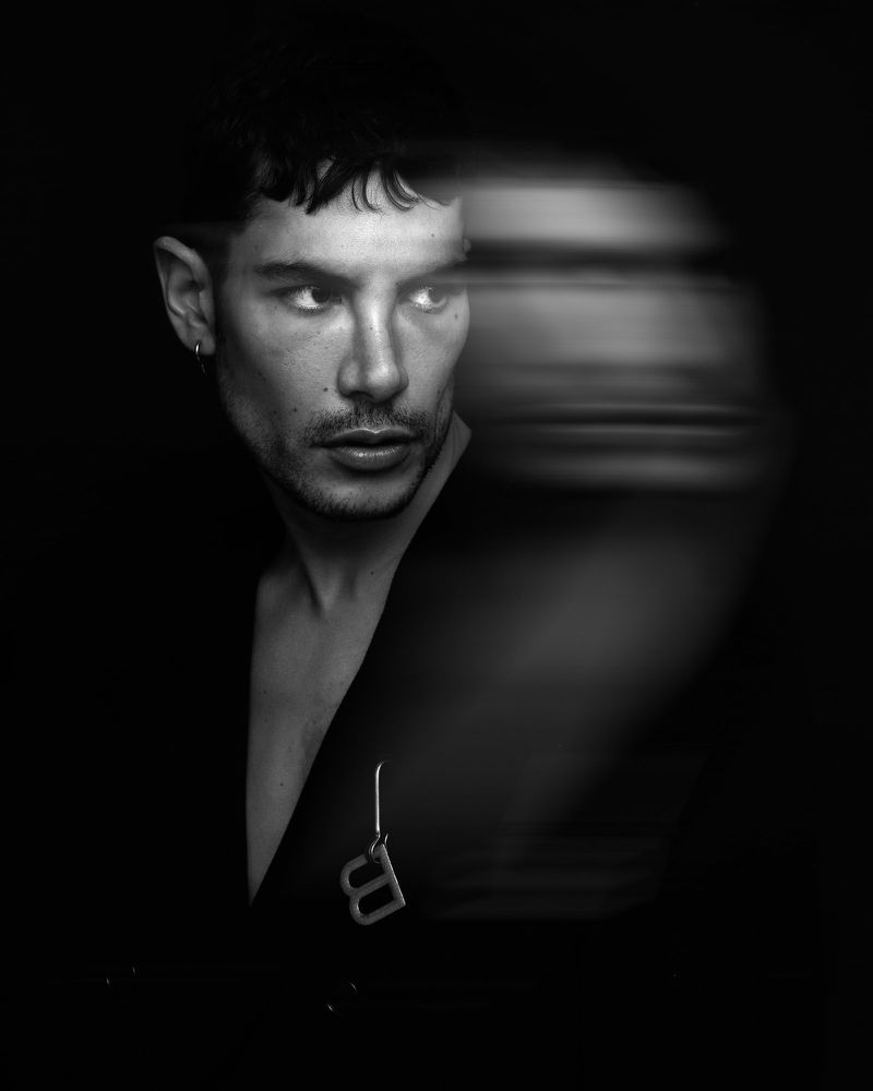 Monochrome portrait of a man with motion blur and a dark jacket for Mirror Mirror Magazine