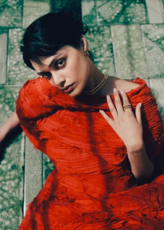 Model Zinnia Kumar wearing a red textured dress in an editorial portrait for Elle India shot by Noemi Ottilia Szabo