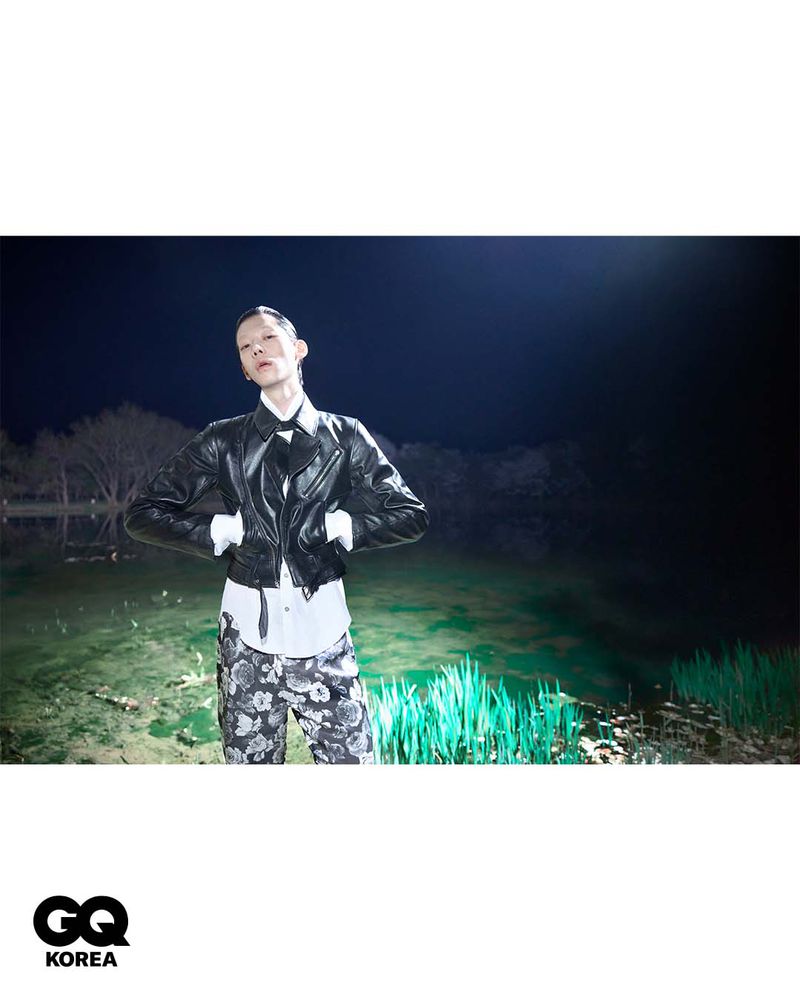 Model wearing black leather jacket and floral pants outdoors at night for GQ Korea