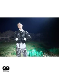 Model wearing black leather jacket and floral pants outdoors at night for GQ Korea