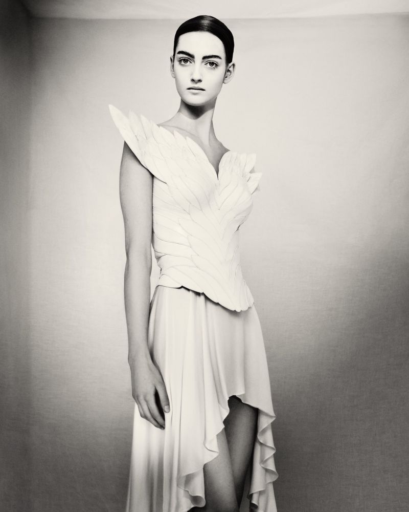 Model wearing a white structured feathered gown photographed in black and white by Paolo Roversi for D Repubblica.