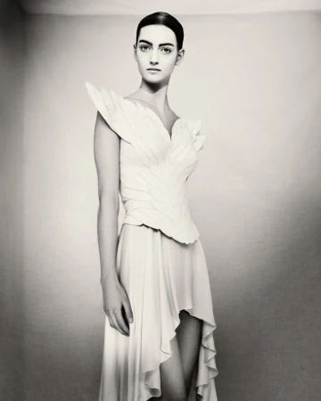 Model wearing a white structured feathered gown photographed in black and white by Paolo Roversi for D Repubblica.