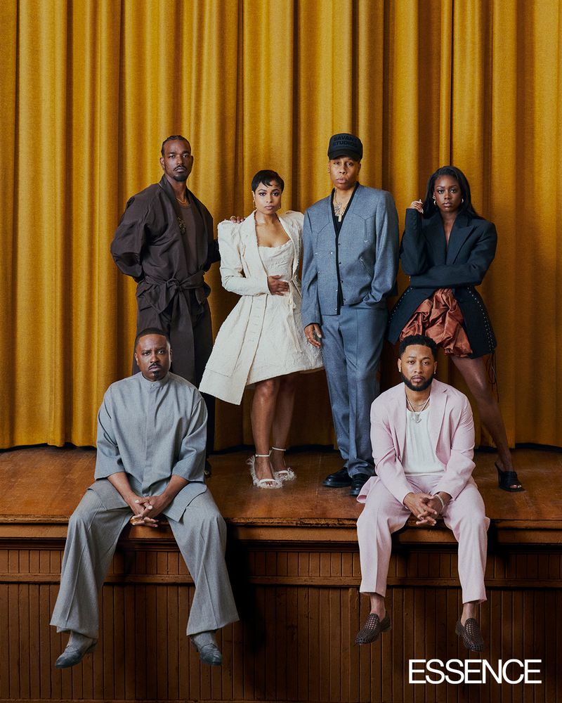 Group portrait of six Black actors on a wooden stage against a pleated gold curtain backdrop for Essence Magazine.