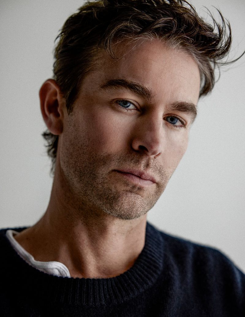 Portrait of Chace Crawford wearing a dark sweater against a plain neutral background
