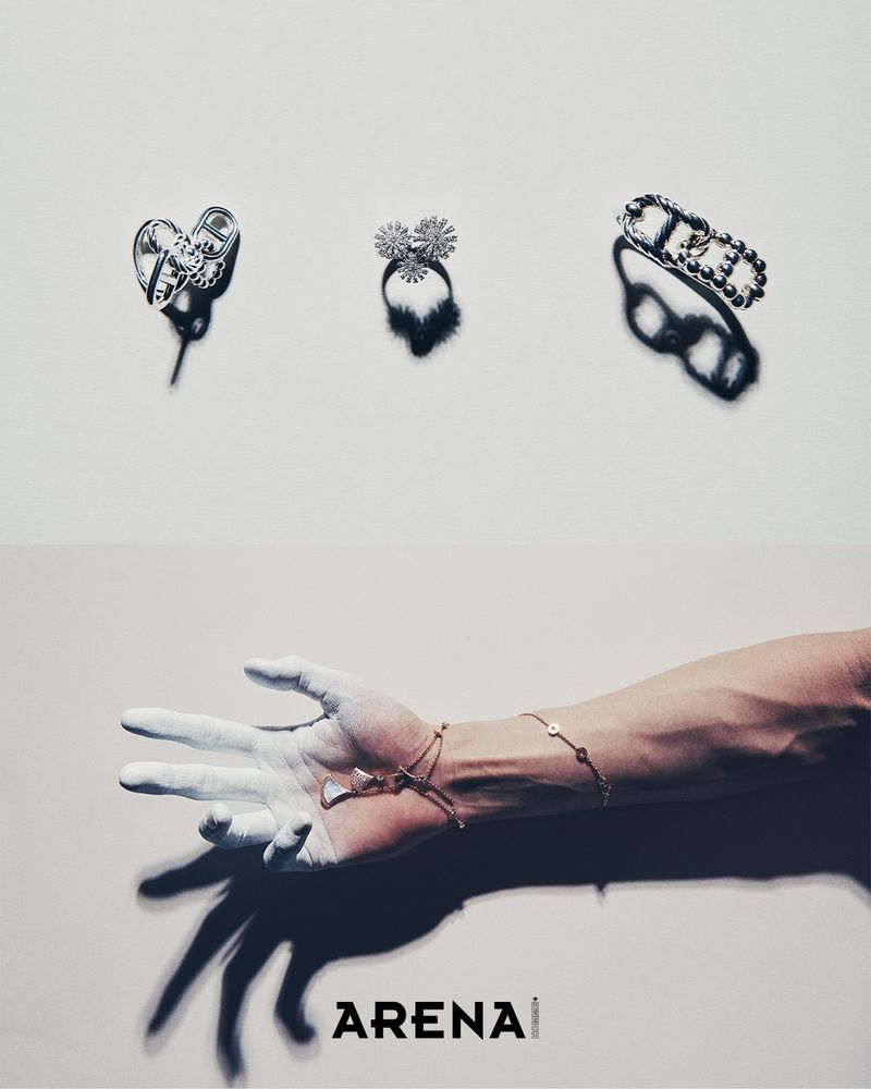 Three rings displayed in the upper section and a white-painted hand wearing delicate bracelets in the lower section on a neutral background.