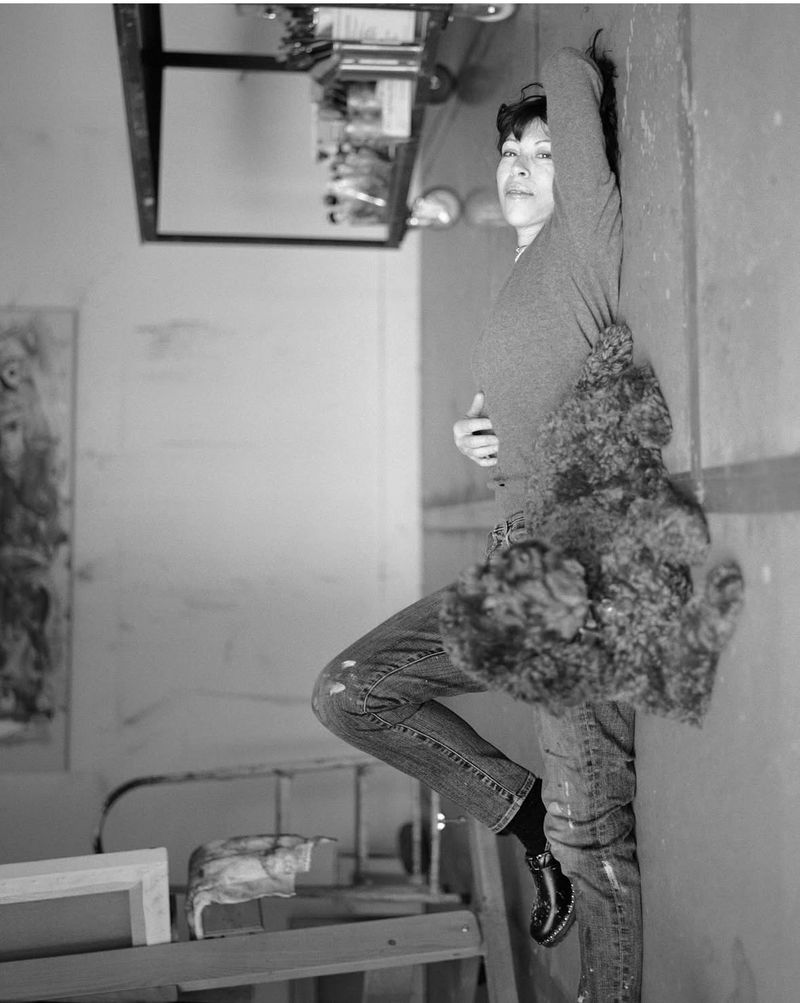 Portrait of Cecily Brown in a studio wearing jeans and a top, captured by Senta Simond for Crosscurrent.