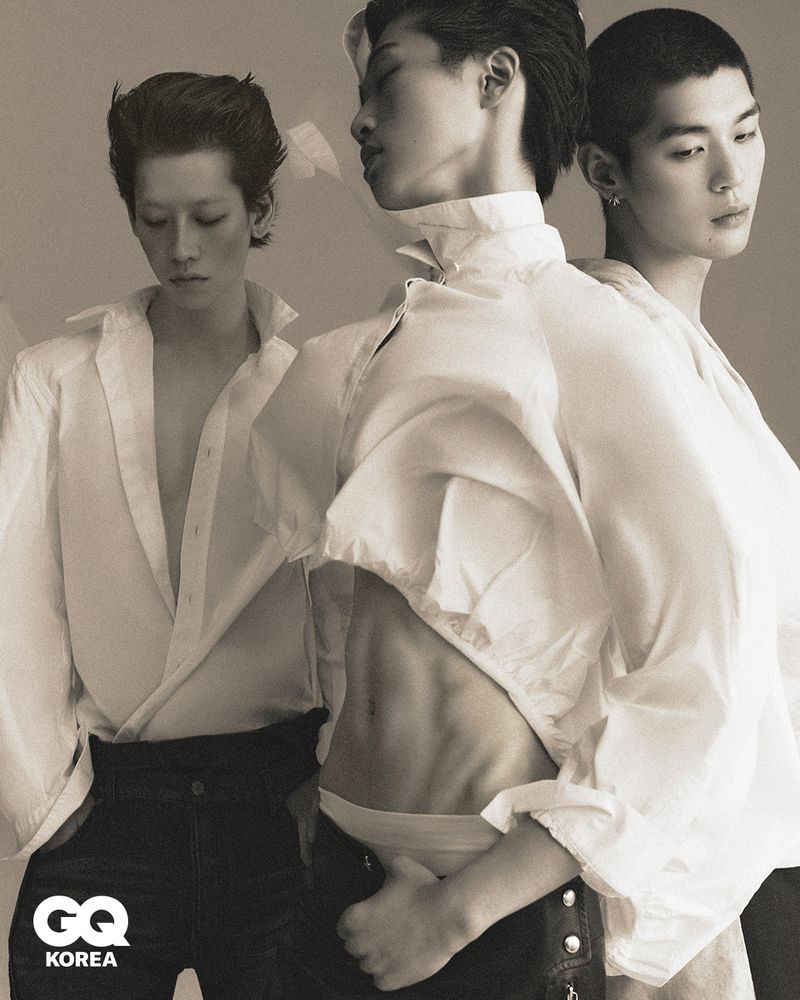 Three male models in white shirts posing together for GQ Korea editorial shot by Yoon Ji Yong.
