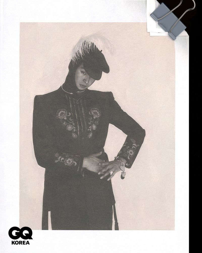 Model Yugo Takano posing in an embroidered black military jacket and feathered cap for GQ Korea