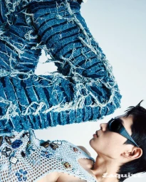 Model Minki Kwon in heavily frayed blue denim and an embellished crochet top with sunglasses for Esquire Korea.