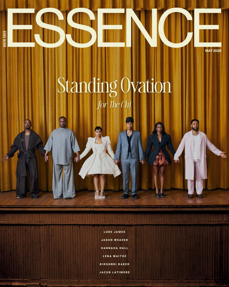 Six cast members of The Chi holding hands in editorial attire on a wooden stage before gold curtains for Essence Magazine.