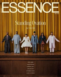 Six cast members of The Chi holding hands in editorial attire on a wooden stage before gold curtains for Essence Magazine.