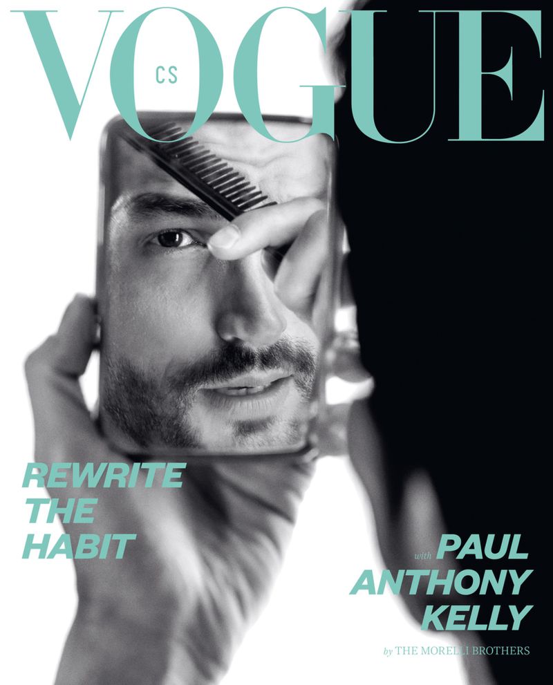 Vogue magazine cover featuring a man's face reflected in a mirror as someone combs his hair, presented in monochrome tones.