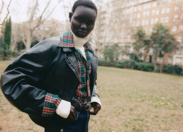 Model Ateta Jok wearing a black leather jacket and plaid shirt outdoors for Vogue Polska photographed by P2a Riverola