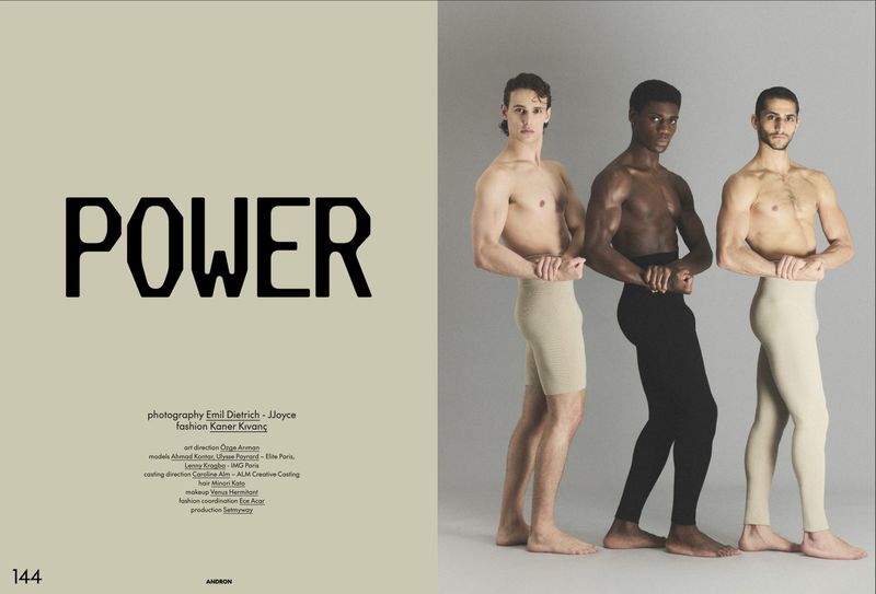 Editorial spread with three shirtless male models posing against a grey seamless studio background for Andron Journal.