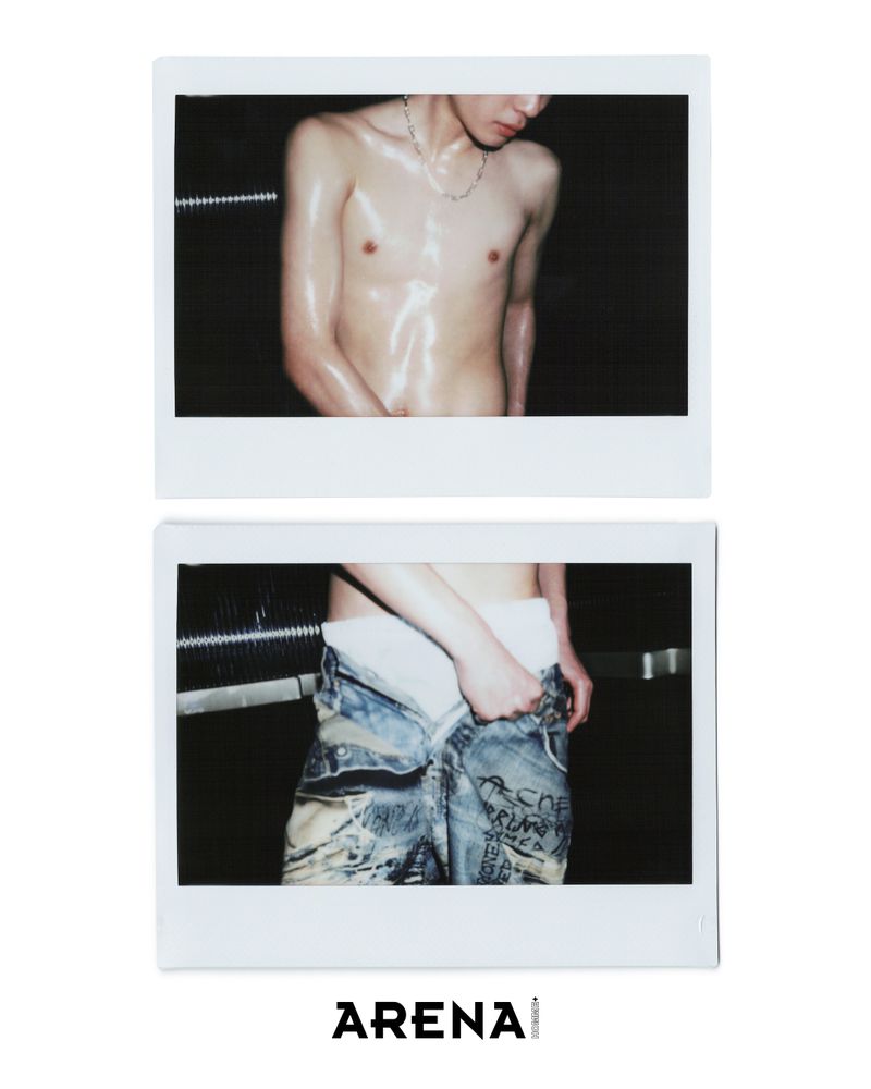 Topless adult male posing in a Polaroid-style close-up, wearing white boxer briefs and printed jeans, against a dark background. 'Arena' logo visible.