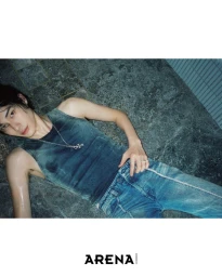 Jinyeong Pak lying on wet stone tiles wearing a faded teal tank top, blue jeans, and silver necklace for Arena Homme+ Korea.