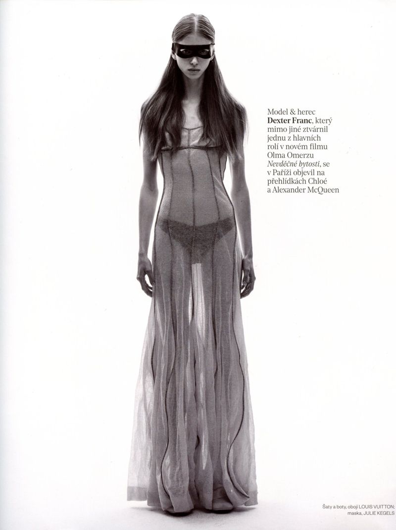 Model Dexter Franc wearing a sheer floor-length dress and black eye mask against a white seamless background for Vogue Czechoslovakia.