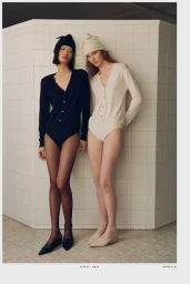 Two female models wearing knit bodysuits and matching beanies pose against a tiled wall for Massimo Dutti Studio.