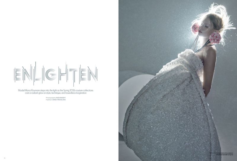 Model Maria Klaumann wearing a sculptural textured white gown with pink floral ear accents on a magazine spread titled Enlighten.