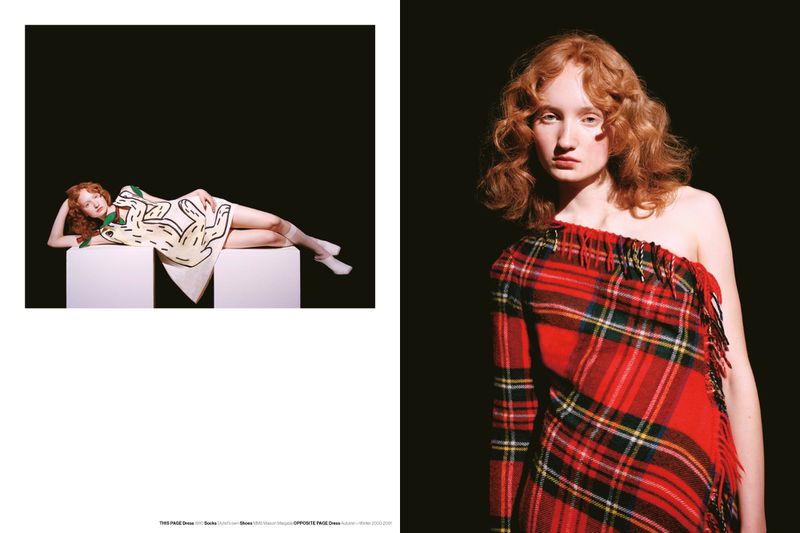 Fashion shot: Red-haired model poses in a plaid dress against a dark background, with a second model in a white graphic dress.