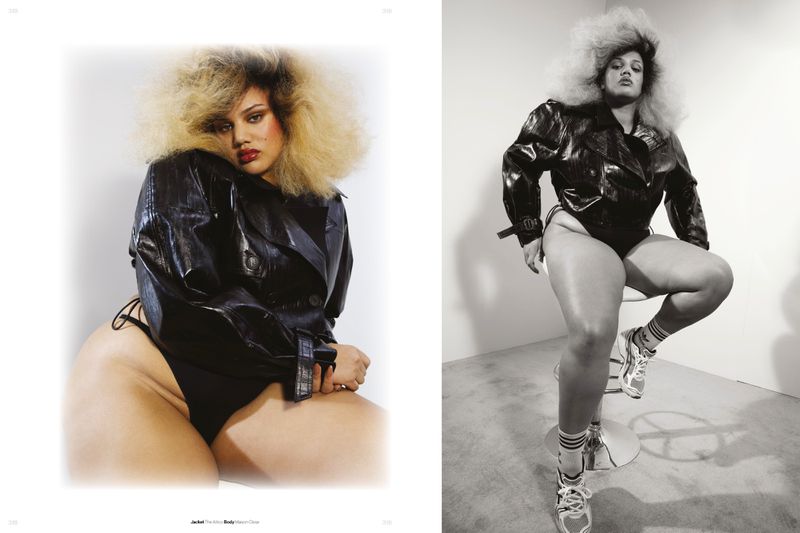 Model with voluminous blonde hair wearing a black glossy leather jacket and bodysuit in a studio fashion editorial spread.