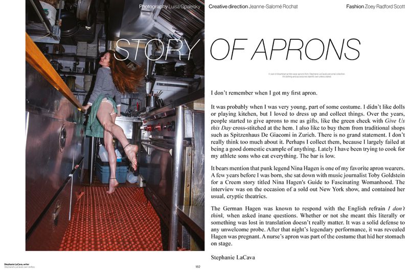 Editorial spread with a woman in a grey sweater and green apron posing barefoot inside a commercial restaurant kitchen.