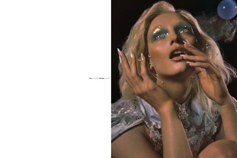 Model Fran Summers with blonde hair, theatrical makeup, and long nails posing for Novembre Magazine editorial by Elizaveta Porodina