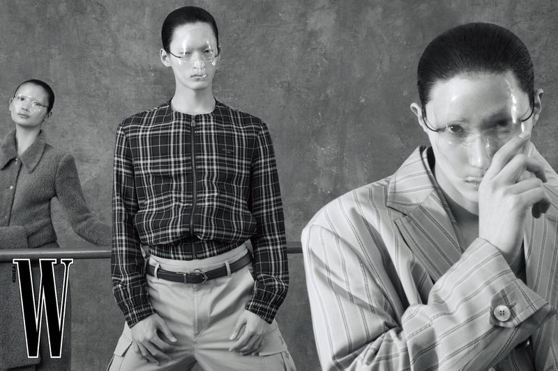 Three models wearing clear face shields and tailored outerwear in a black and white editorial shoot for W Korea.